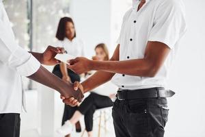 aan het doen handdruk. geslaagd overeenkomst. groep van Afrikaanse Amerikaans bedrijf mensen werken in kantoor samen foto