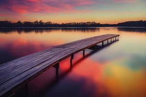 kleurrijk houten pier Aan een meer dat is totaal kalmte gedurende zonsondergang foto