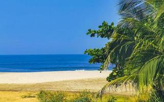 zon strand mensen golven en boten in puerto escondido Mexico. foto