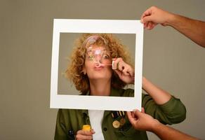 vrouw in afbeelding kader blazen bubbels foto