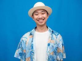 toerisme Mens slijtage hoed teder glimlach geïsoleerd blauw achtergrond foto