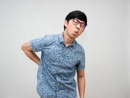 Aziatisch mannetje werknemer slijtage bril voelt pijn zijn terug over moeilijk werken kantoor syndroom geïsoleerd foto
