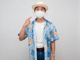 toerisme Aziatisch Mens strand overhemd punt vinger Bij gezicht masker geïsoleerd foto