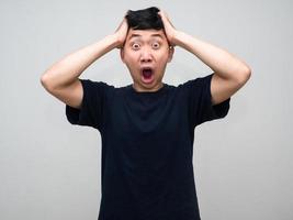 jong Aziatisch Mens voelt geschokt houden zijn hoofd geïsoleerd foto