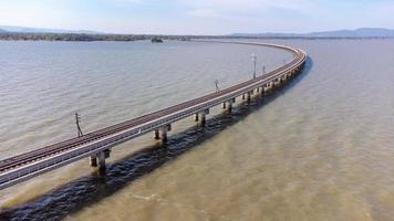 antenne visie van een verbazingwekkend reizen trein geparkeerd Aan een drijvend spoorweg brug over- de water van de meer in vader sak jolasid dam met blauw lucht Bij lopburi, Thailand. foto