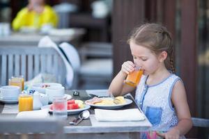 meisje sap drinken bij het ontbijt foto