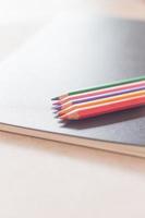 kleurpotloden op een zwarte notebook foto