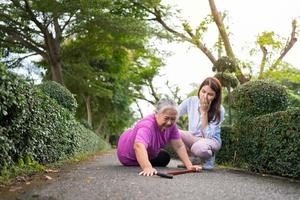 Aziatisch senior vrouw viel naar beneden Aan aan het liegen verdieping omdat flauw en ledemaat zwakheid en huilen in pijn het formulier ongeluk en haar dochter kwam naar helpen steun. concept van oud ouderen verzekering en Gezondheid zorg foto