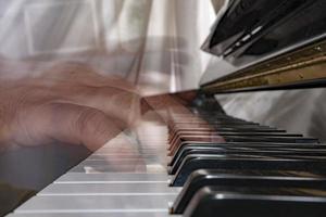 handen spelen piano terwijl in beweging foto