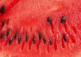 besnoeiing structuur van rood rijp watermeloen met bruin zaden, vol kader foto