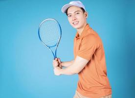 beeld van jong Aziatisch Mens Holding tennis racket foto