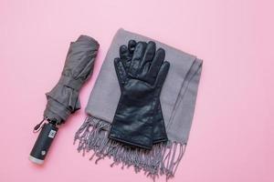 herfst accessoires paraplu, handschoenen en tippet Aan roze achtergrond foto