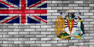 Brits antarctisch gebied vlag Aan een getextureerde achtergrond. concept collage. foto