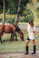 jong vrouw met wild paard buitenshuis foto