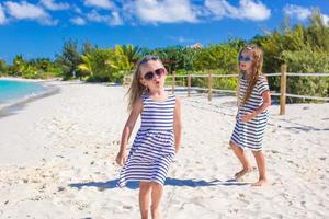 weinig meisjes hebben pret gedurende tropisch strand vakantie foto