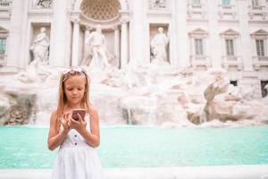 aanbiddelijk weinig meisje achtergrond Trevi fontein, Rome, Italië. gelukkig toodler kind genieten Italiaans vakantie vakantie in Europa. foto