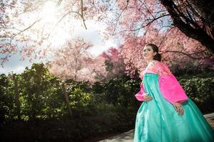 hanbok, de traditioneel Koreaans jurk en mooi Aziatisch meisje met sakura foto