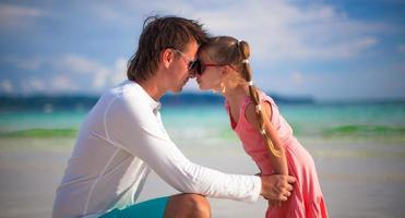 gelukkig vader en aanbiddelijk weinig dochter Aan de strand foto