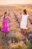 meisjes in lavendel bloemen veld- Bij zonsondergang in wit jurk foto