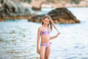 gelukkig weinig meisje wandelen Bij strand gedurende caraïben vakantie foto