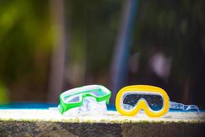 twee nat scuba maskers aan het liegen in de buurt zwemmen zwembad foto