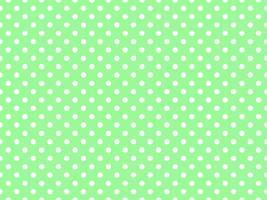 wit polka dots over- pale groen achtergrond foto