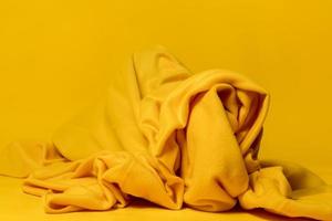 geel, verfrommeld plaid Aan een helder achtergrond. abstract behang. foto