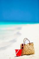 strandaccessoires - strozak, witte hoed en rode zonnebril op het strand foto