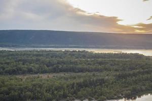 zonsondergang Aan de volga rivier. natuurlijk landschap. reflectie, blauw lucht en geel zonlicht. landschap gedurende zonsondergang. foto