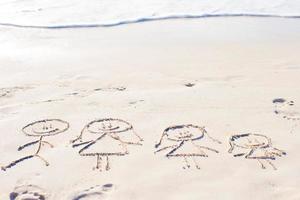 familie symbool getrokken Aan strand wit zand foto