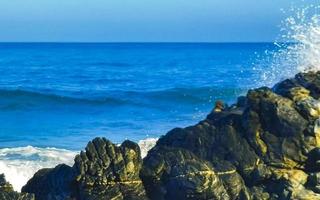 mooi rotsen kliffen surfer golven Bij strand puerto escondido Mexico. foto