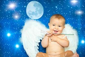 baby een weinig maanden met een magie toverstaf en engel Vleugels foto