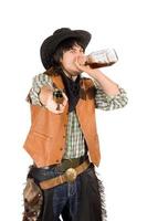 cowboy drinken whisky van de fles foto