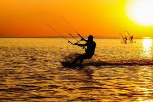 silhouetten van een windsurfers foto