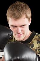 grijnzend jong Mens in boksen handschoenen foto