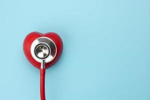 stethoscoop en rood hart op blauwe achtergrond foto