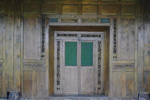 een foto van een traditioneel Javaans huis gemaakt van hout en traditioneel kroonluchter