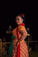 een Aziatisch traditioneel danser in een oranje jurk met een rood sjaal en bedenken het uitvoeren van Bij de dans festival foto