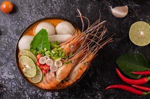 tom yum soep met garnalen en krab met limoen, chili, tomaat en knoflook foto