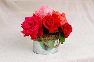 mooi boeket van kleurrijk rozen in afgeronde metaal doos geïsoleerd Aan roze achtergrond met vrij copyspace voor tekst, afbeelding voor groet vakantie kaart, behang, kalender, poster, lente bloemen ansichtkaart foto