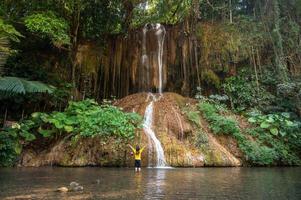 toerist staand in voorkant van phu zong waterval de enkel en alleen een warm waterval in Thailand met temperatuur over 35 graden Celsius. gelegen Bij grens van phayao en Chiang rai provincie. foto