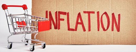 consumenten inflatie concept, boodschappen doen trolley en woord inflatie foto