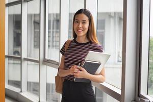 mooi vrouw leerling met een boek in hoog school- of Universiteit foto