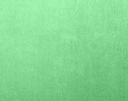 fragment van groen cement muur met onregelmatigheden foto