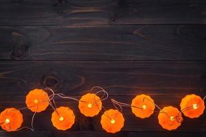 halloween achtergrond, pompoen draad lichten Aan houten tafel foto