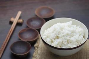 Thaise witte rijst met stokjes op houten achtergrond foto