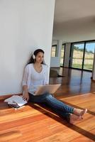 ontspannen jong vrouw Bij huis werken Aan laptop foto