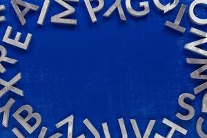 kader mockup gemaakt van van zilver metaal Engels alfabet tekens Aan blauw achtergrond. foto
