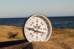 kompas Aan de zand foto