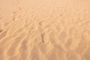 dichtbij omhoog zand structuur patroon achtergrond van een strand in de zomer foto